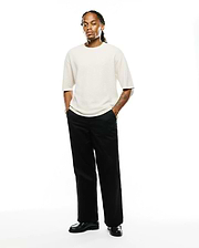 Mens Makai Textured Knit T-Shirt in cream, featuring a relaxed fit and a subtle ribbed texture. A small, embroidered Psycho Bunny skull logo is on the left chest.