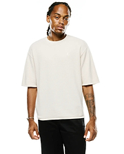 Mens Makai Textured Knit T-Shirt in cream, featuring a relaxed fit, horizontal textured knit fabric, and a small embroidered Psycho Bunny skull logo on the left chest.