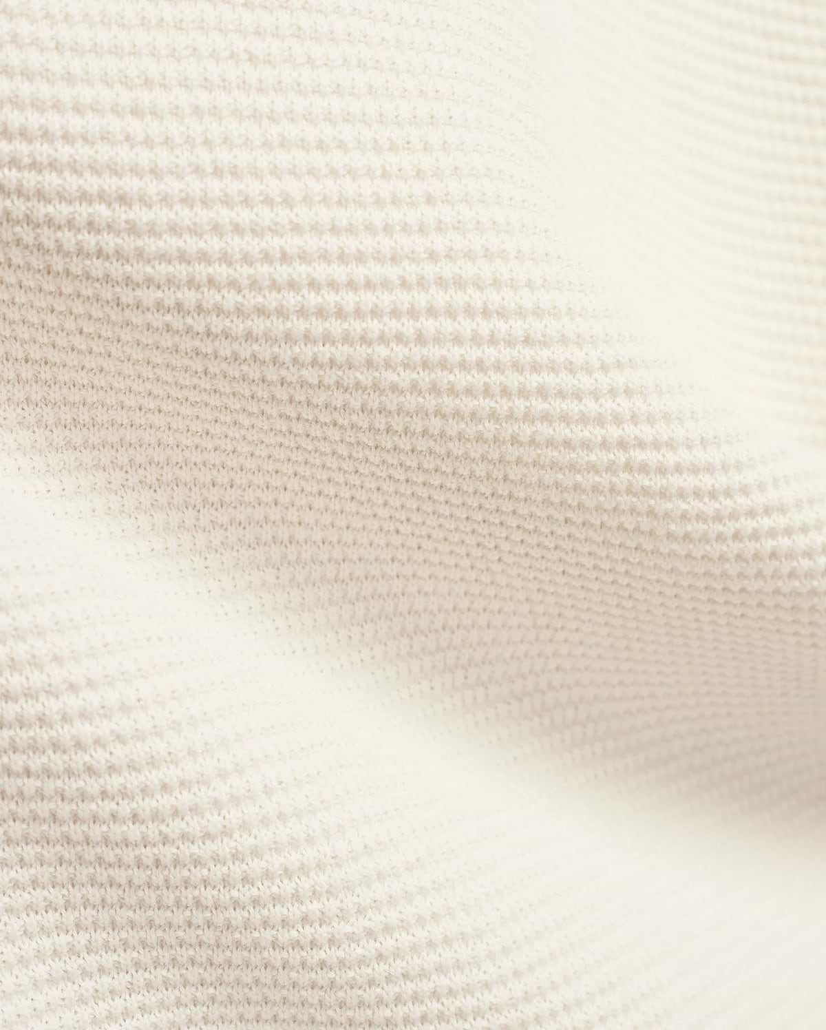 Mens Makai Textured Knit T-Shirt in creamy off-white, showcasing a refined, subtly raised pique-like knit fabric texture, ideal for premium Psycho Bunny streetwear style.