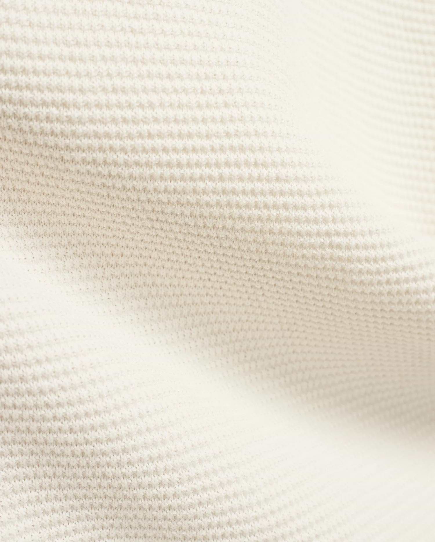 Mens Makai Textured Knit T-Shirt in creamy off-white, showcasing a refined, subtly raised pique-like knit fabric texture, ideal for premium Psycho Bunny streetwear style.
