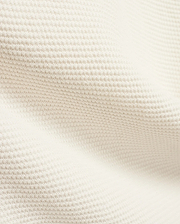 Mens Makai Textured Knit T-Shirt in creamy off-white, showcasing a refined, subtly raised pique-like knit fabric texture, ideal for premium Psycho Bunny streetwear style.