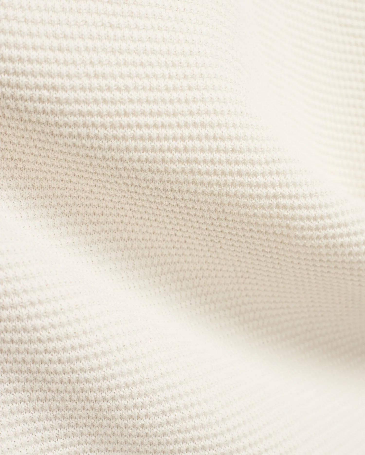 Mens Makai Textured Knit T-Shirt in creamy off-white, showcasing a refined, subtly raised pique-like knit fabric texture, ideal for premium Psycho Bunny streetwear style.