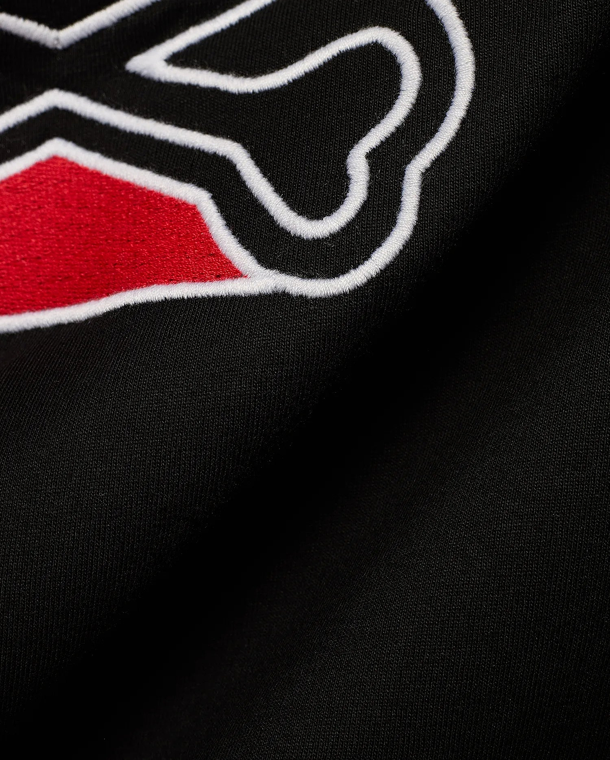 Men's Lowell Graphic Tee in classic black jersey knit, showcasing a prominent, textured embroidered graphic with vibrant red fill and a sharp white outline, embodying refined streetwear. (6)