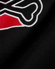 Men's Lowell Graphic Tee in classic black jersey knit, showcasing a prominent, textured embroidered graphic with vibrant red fill and a sharp white outline, embodying refined streetwear. (6)