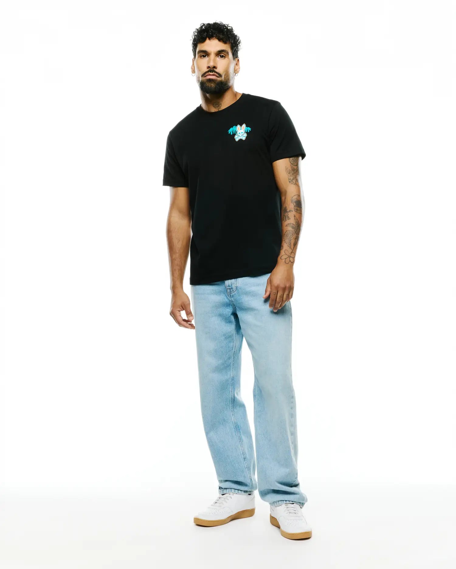 Mens Miami Back Graphic Tee in black, featuring a classic fit and soft jersey knit. A small embroidered teal and white Psycho Bunny skull logo with palm trees adorns the left chest. (3)