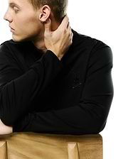 Men's Oscar Longsleeve Tee, a classic fit black jersey knit shirt featuring a small, tonal black embroidered Psycho Bunny skull logo on the left chest. (3)