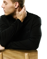 Men's Oscar Longsleeve Tee, a classic fit black jersey knit shirt featuring a small, tonal black embroidered Psycho Bunny skull logo on the left chest. (3)