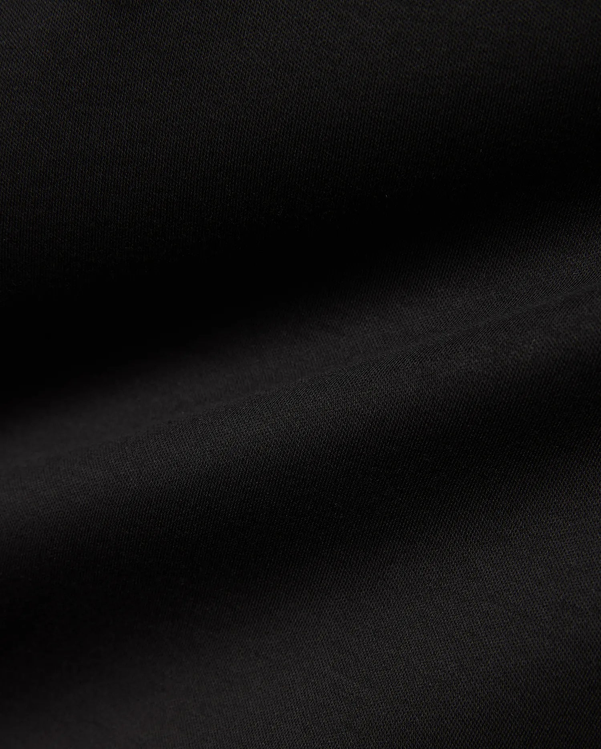 Men's Oscar Longsleeve Tee, a luxurious deep black jersey knit fabric, showcasing a smooth, soft texture with subtle, flowing folds, indicative of premium quality menswear. (6)