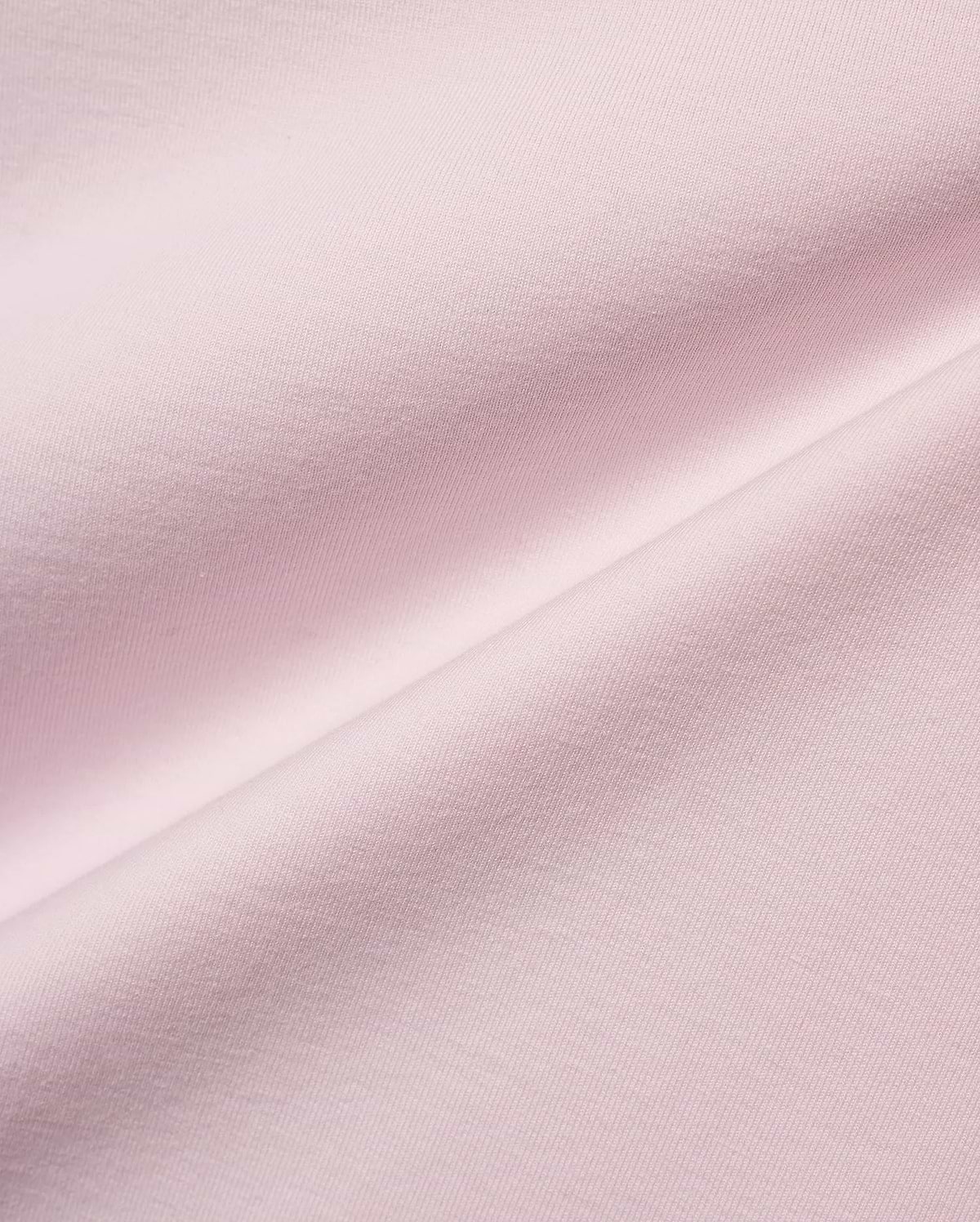 Men's Jim Jersey Longsleeve Shirt, a close-up of the premium light pink jersey knit fabric, showcasing its soft, smooth texture with subtle diagonal ribbing and elegant draping folds. (5)