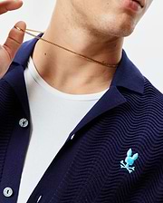Mens Holden Oversized Knit Shirt in navy blue, featuring a distinct wavy knit texture, a small light blue embroidered Psycho Bunny skull logo on the left chest, and branded silver buttons. (2)