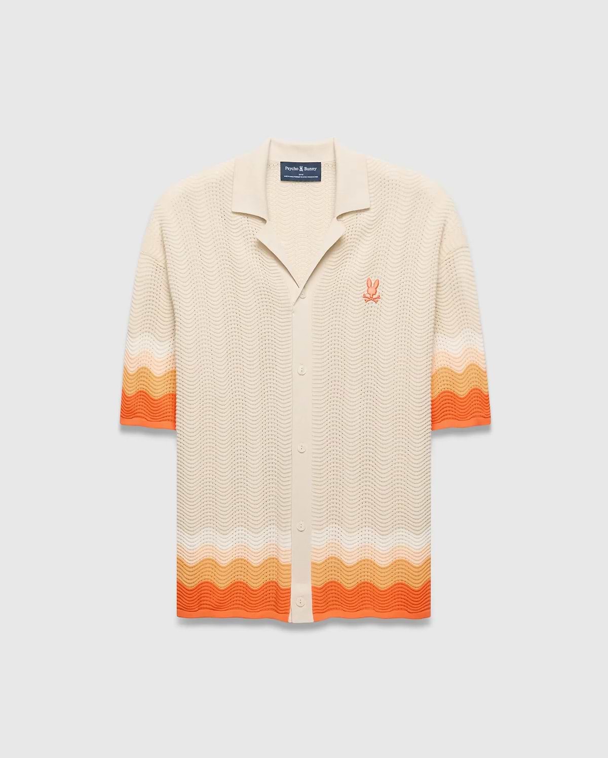 Cream Mens Holden Relaxed Fit Knit Shirt with a wavy texture, featuring an orange and peach ombre stripe on the sleeves and hem, and an embroidered orange Psycho Bunny skull logo on the left chest. (5)