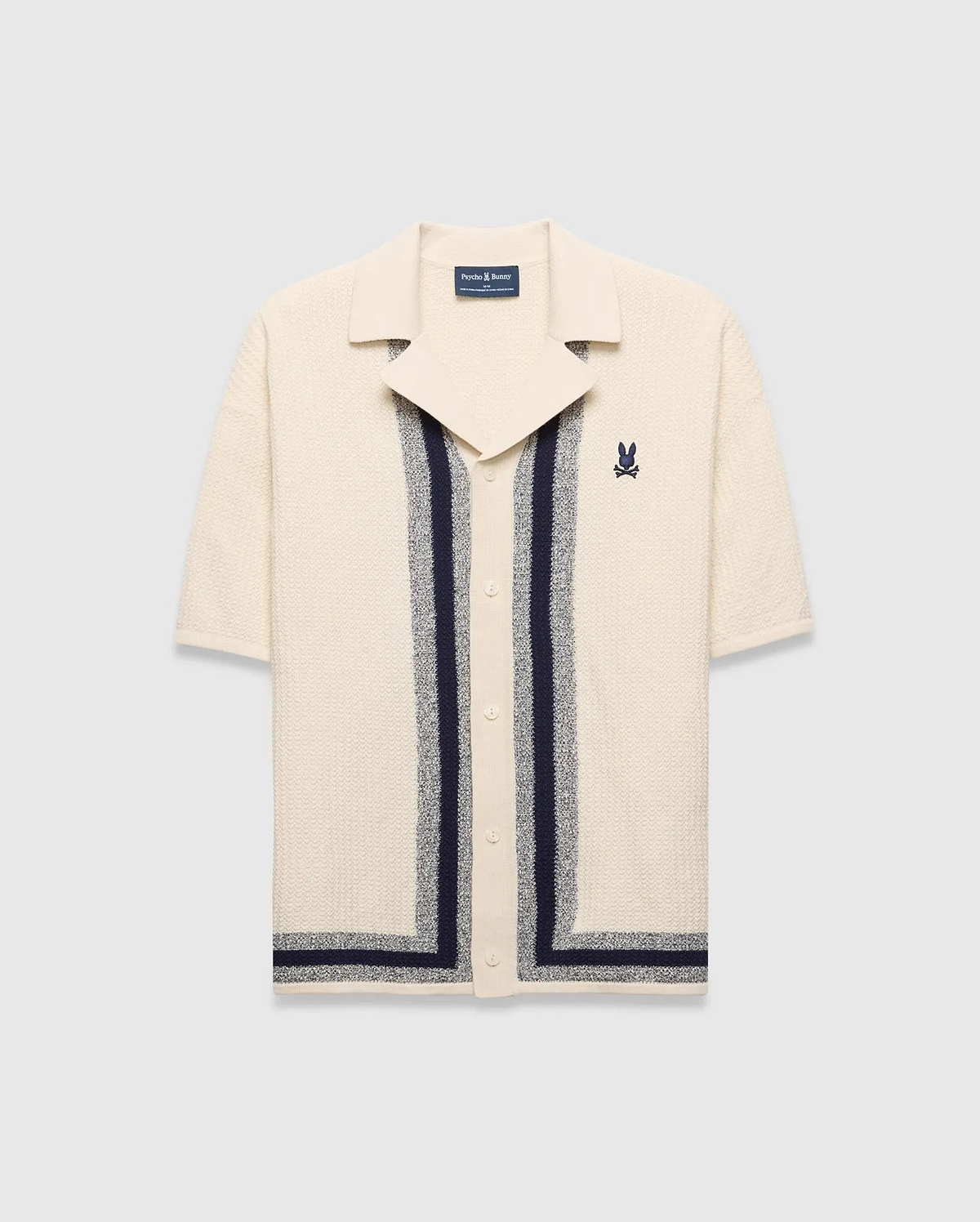 Mens Giles Relaxed Fit Border Knit Shirt in cream textured knit with navy and heathered grey vertical stripes, a spread collar, and an embroidered Psycho Bunny skull logo on the left chest.