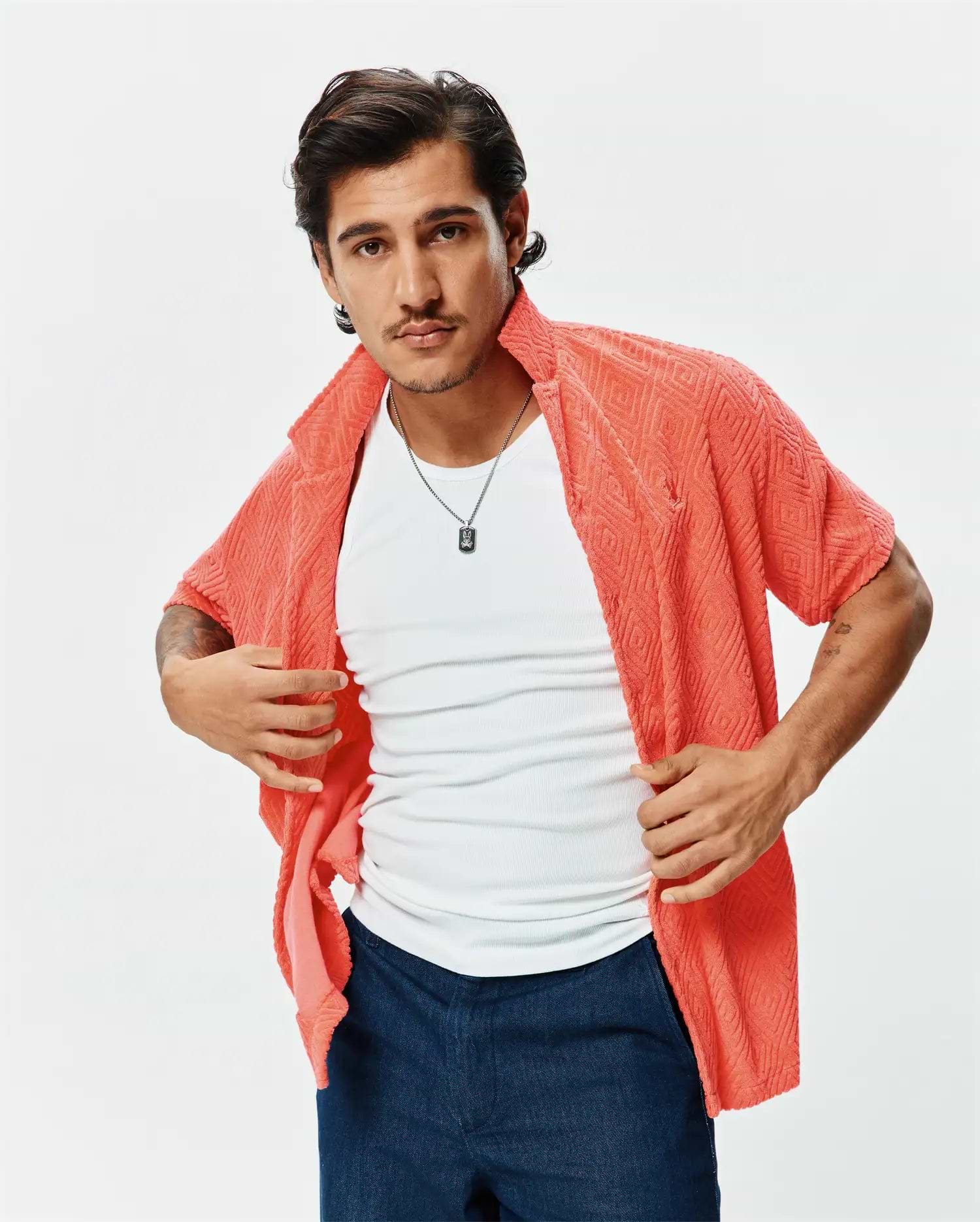Mens Tristan Shirt: Relaxed fit coral short-sleeve shirt in textured terry fabric with a diamond pattern, featuring a small embroidered Psycho Bunny skull logo on the left chest. (1)