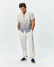 Psycho Bunny Mens Tobias Tencel Shirt, a premium relaxed fit short-sleeve camp collar shirt featuring a unique off-white and navy blue fading geometric diamond pattern, crafted from smooth, breathable Tencel fabric.