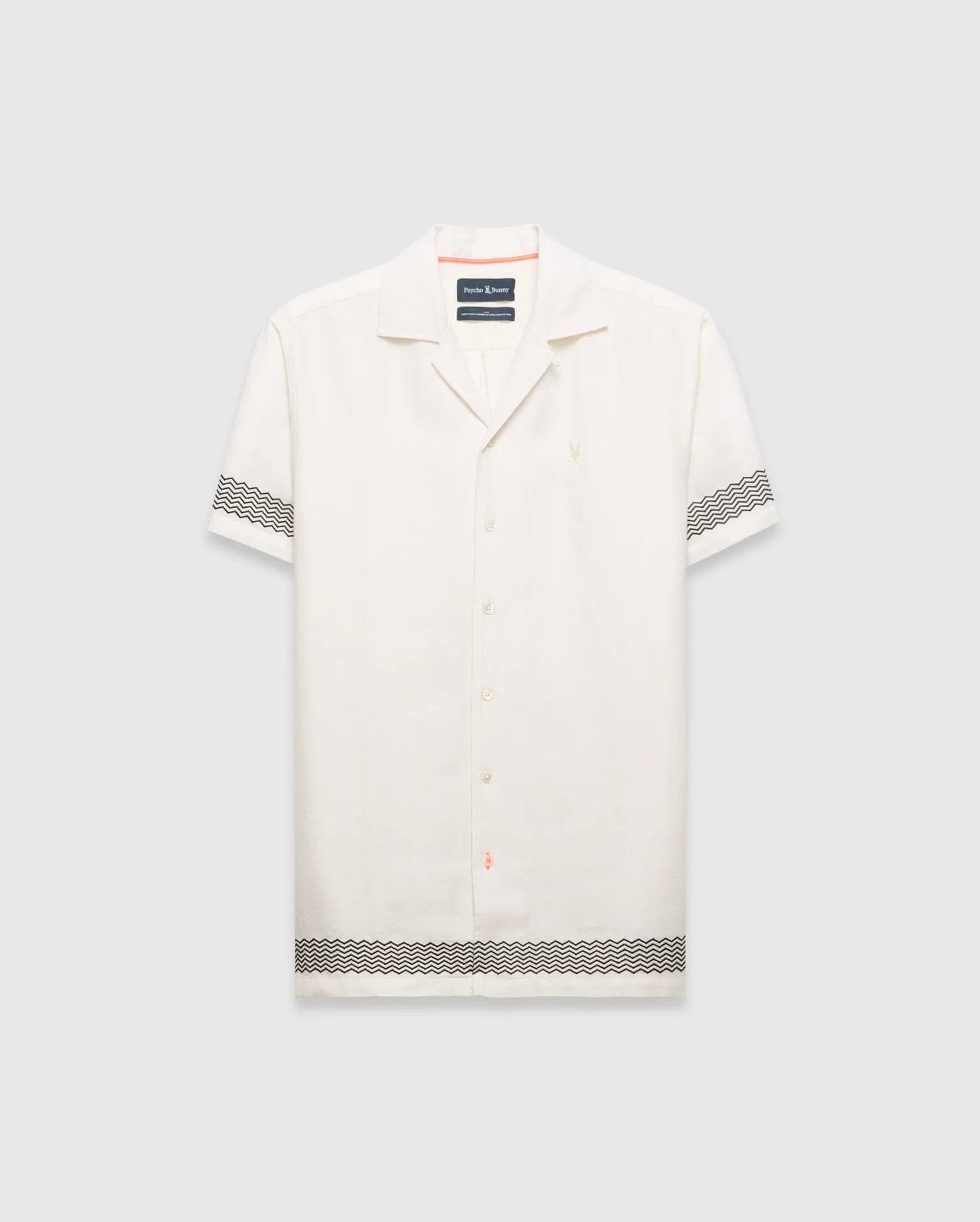 Mens Sunny Linen Shirt, an off-white relaxed linen camp collar shirt, features black zigzag patterns on sleeves and hem, an embroidered Psycho Bunny logo left chest, and orange collar trim. (5)