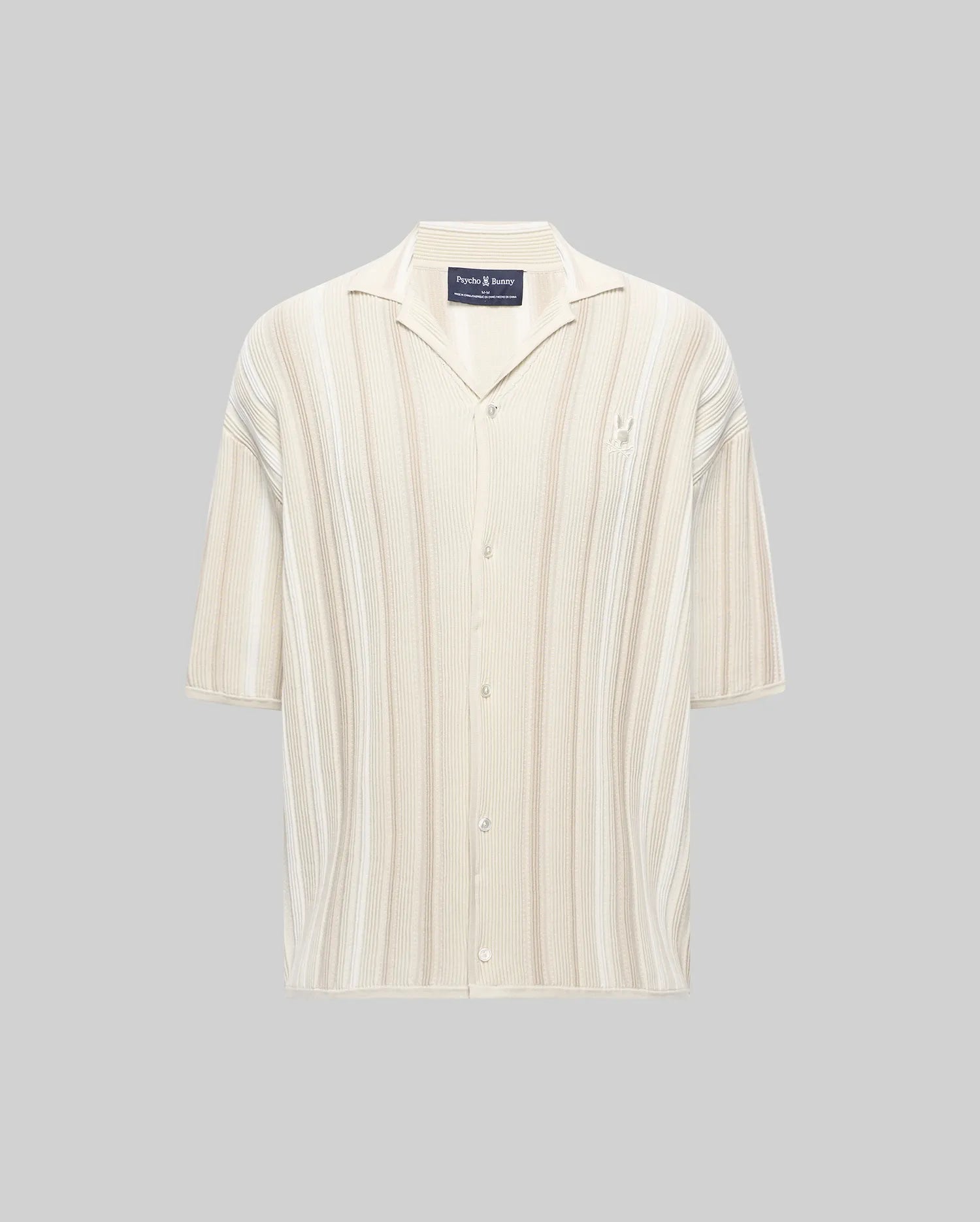 Mens Cliff Shirt, a relaxed fit cream and beige striped ribbed knit button-up with a camp collar, short sleeves, and a small embroidered Psycho Bunny skull logo on the left chest.