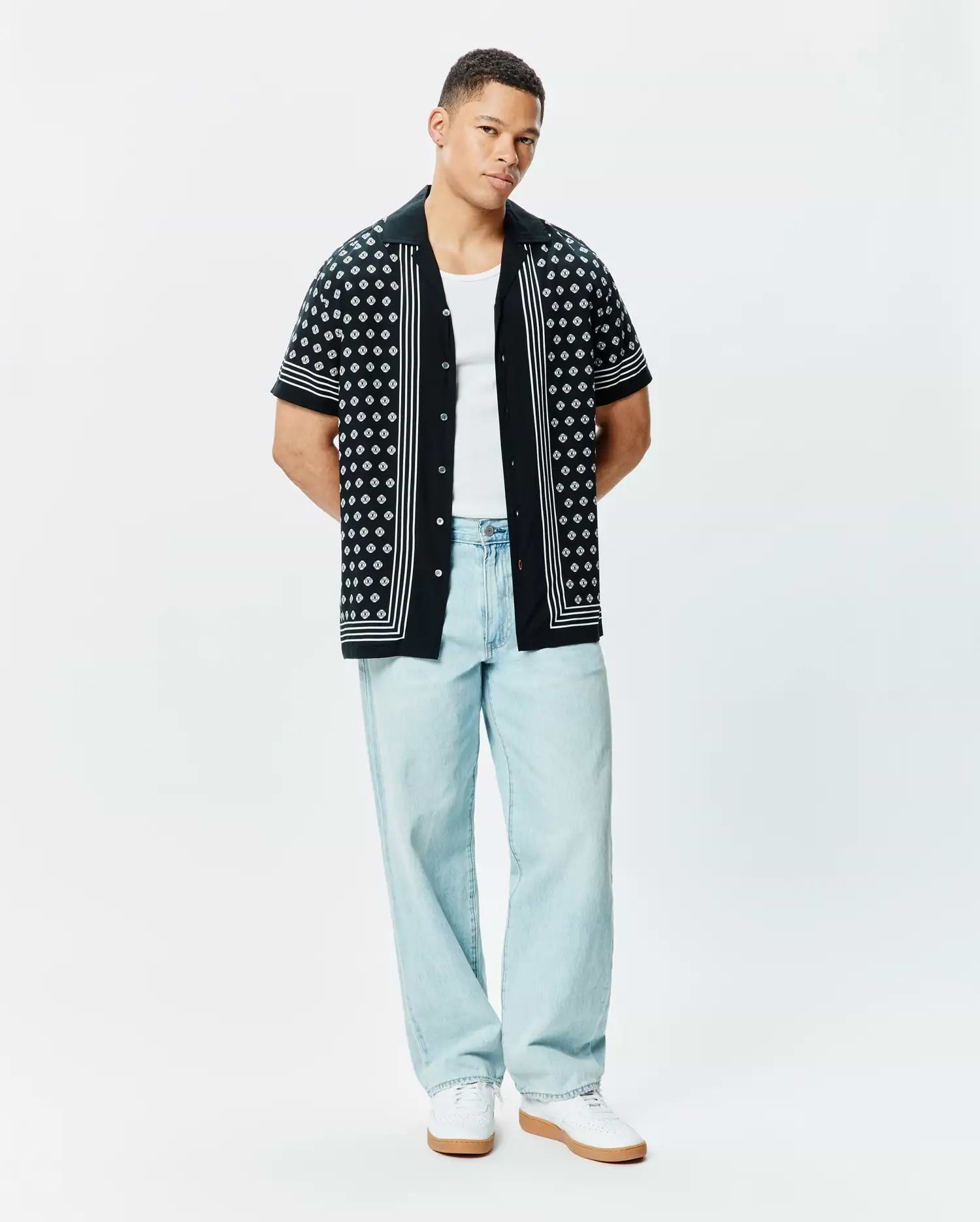 Mens Nick Tencel Shirt, a black relaxed-fit short-sleeve button-up with a camp collar, featuring an all-over white geometric bunny skull pattern and white vertical stripe accents.