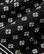 Black Mens Nick Tencel Shirt, a premium streetwear piece with a smooth Tencel weave, featuring an all-over white Psycho Bunny skull logo pattern and a bold white stripe accent.