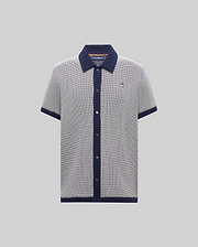 Mens Maxton Waffle Shirt, a classic short-sleeve polo in navy/white micro-pattern waffle knit, solid navy collar, placket, cuffs, hem, and embroidered Psycho Bunny skull logo on left chest.