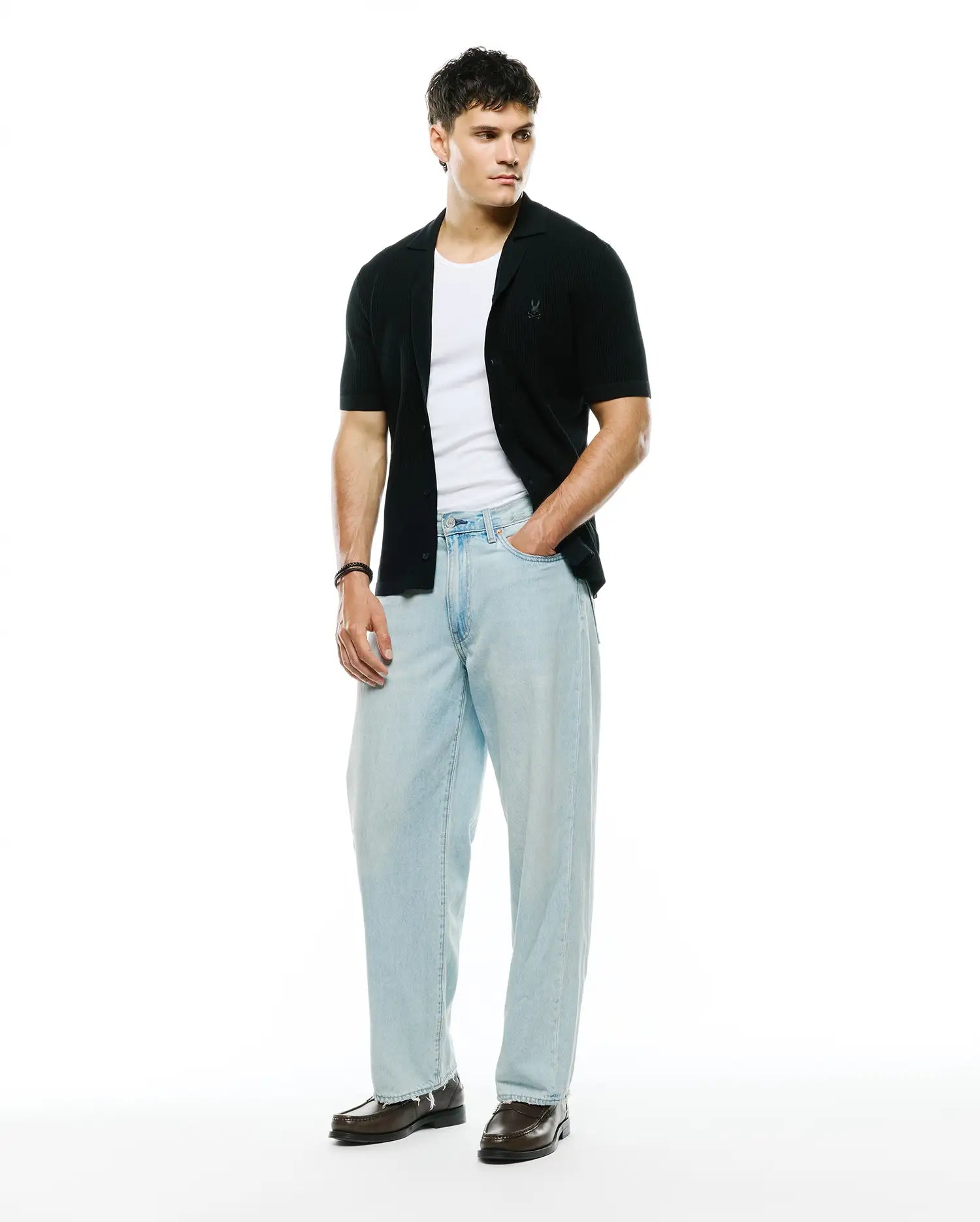 Mens Yann Knit Shirt, black ribbed knit, classic fit, short-sleeve button-front with camp collar and small embroidered Psycho Bunny skull logo on left chest.
