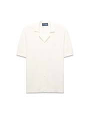 Mens Yann Knit Shirt, cream ribbed knit, short-sleeve, full button-front, camp collar, with a small embroidered Psycho Bunny skull logo on the left chest, classic fit.