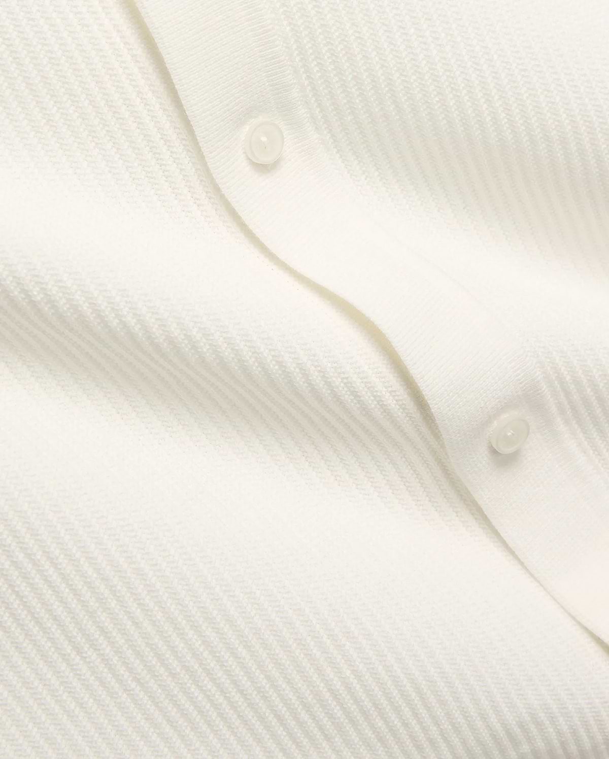 Mens Yann Knit Shirt by Psycho Bunny, a crisp white knit top with a subtle diagonal chevron pattern, featuring a clean button placket with translucent buttons.