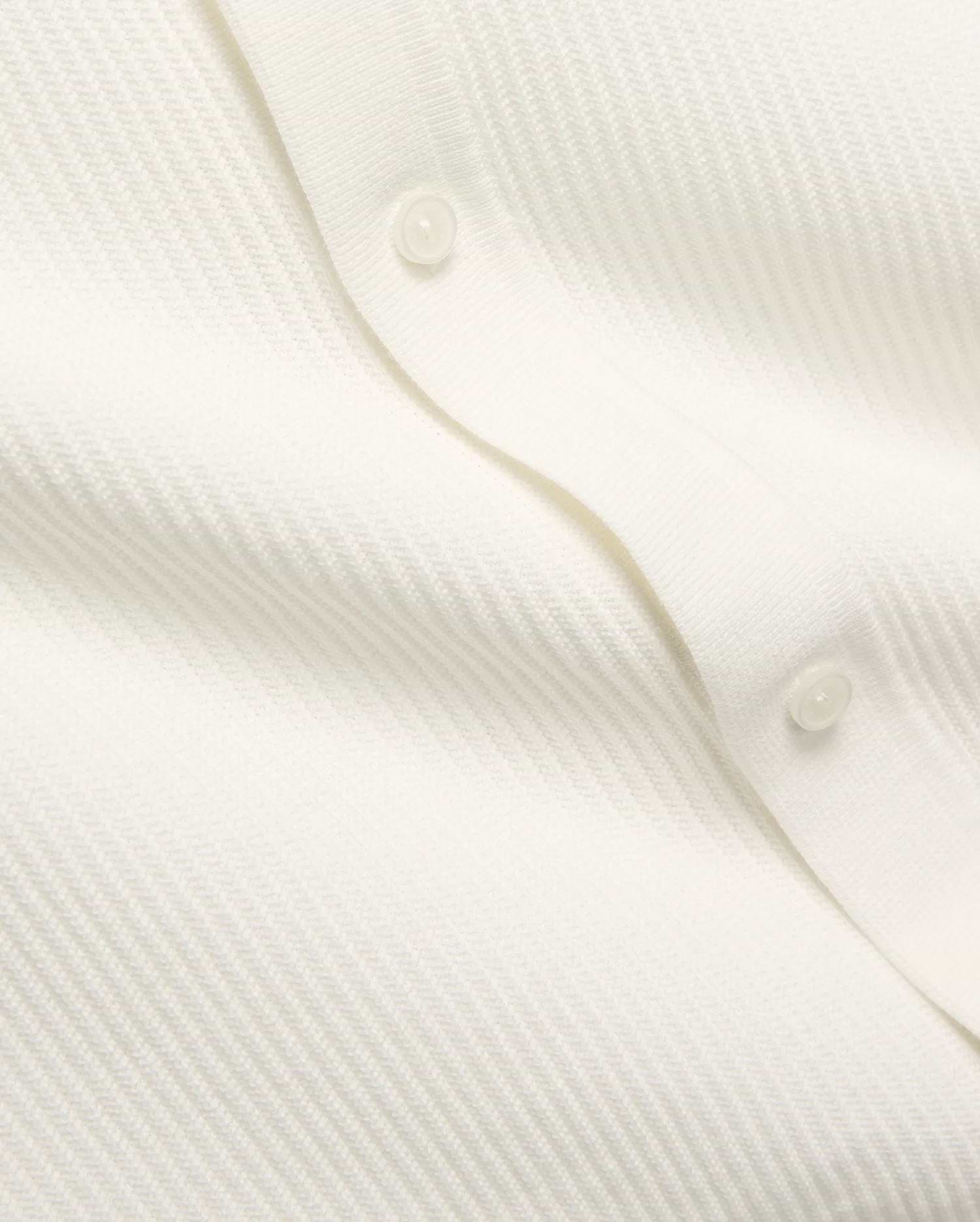 Mens Yann Knit Shirt by Psycho Bunny, a crisp white knit top with a subtle diagonal chevron pattern, featuring a clean button placket with translucent buttons.