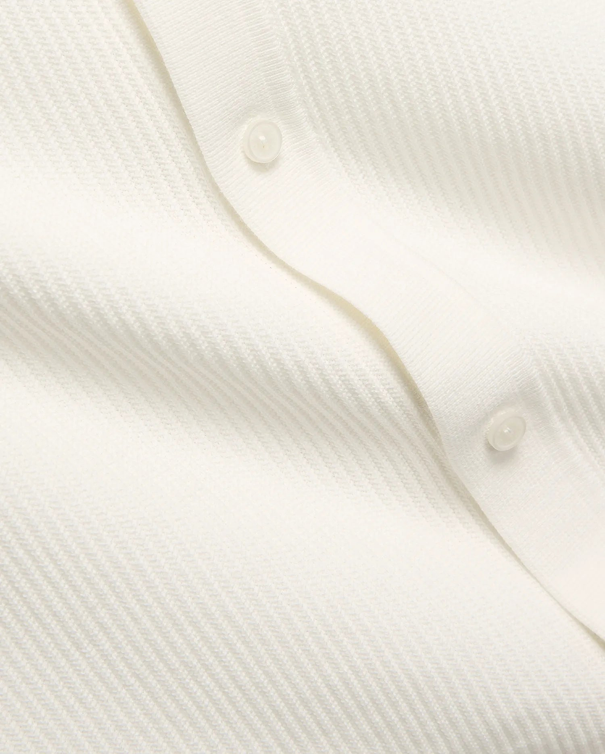Mens Yann Knit Shirt by Psycho Bunny, a crisp white knit top with a subtle diagonal chevron pattern, featuring a clean button placket with translucent buttons.