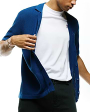 Mens Yann Knit Shirt in vibrant blue with a ribbed texture, featuring a classic collar and front buttons, layered over a white jersey t-shirt with a small, embroidered pink and white Psycho Bunny skull logo on the left chest.