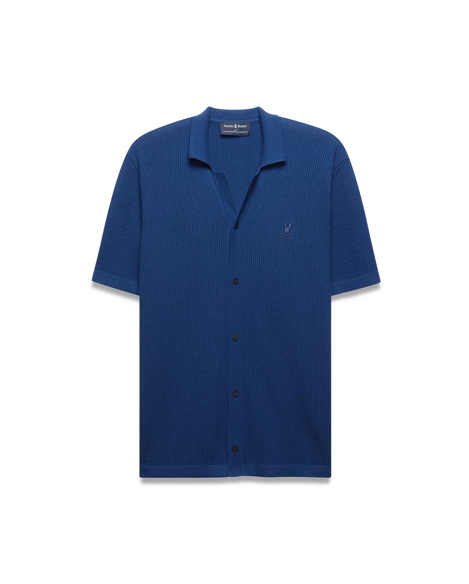 Mens Yann Knit Shirt in deep blue, featuring a ribbed knit texture, open collar, short sleeves, black button placket, and a small embroidered Psycho Bunny skull logo on the left chest.