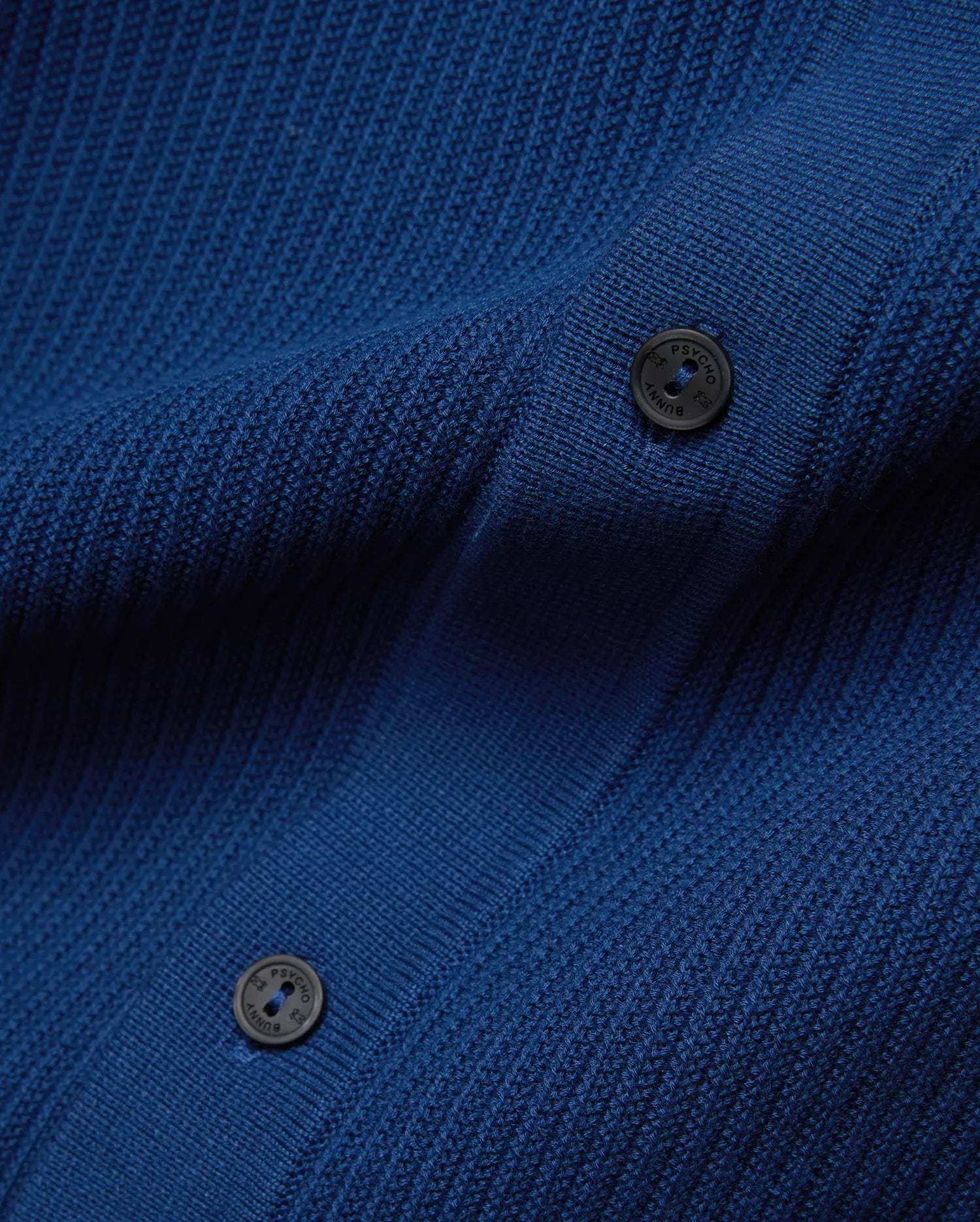 Mens Yann Knit Shirt in vibrant royal blue, featuring a premium, refined, subtly textured knit fabric and dark, branded Psycho Bunny buttons.