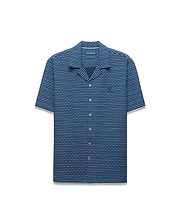 Mens Erik Raised Check Shirt. Relaxed fit short-sleeve blue camp collar shirt with a raised blue and grey check pattern, featuring a small embroidered Psycho Bunny skull logo on the left chest.