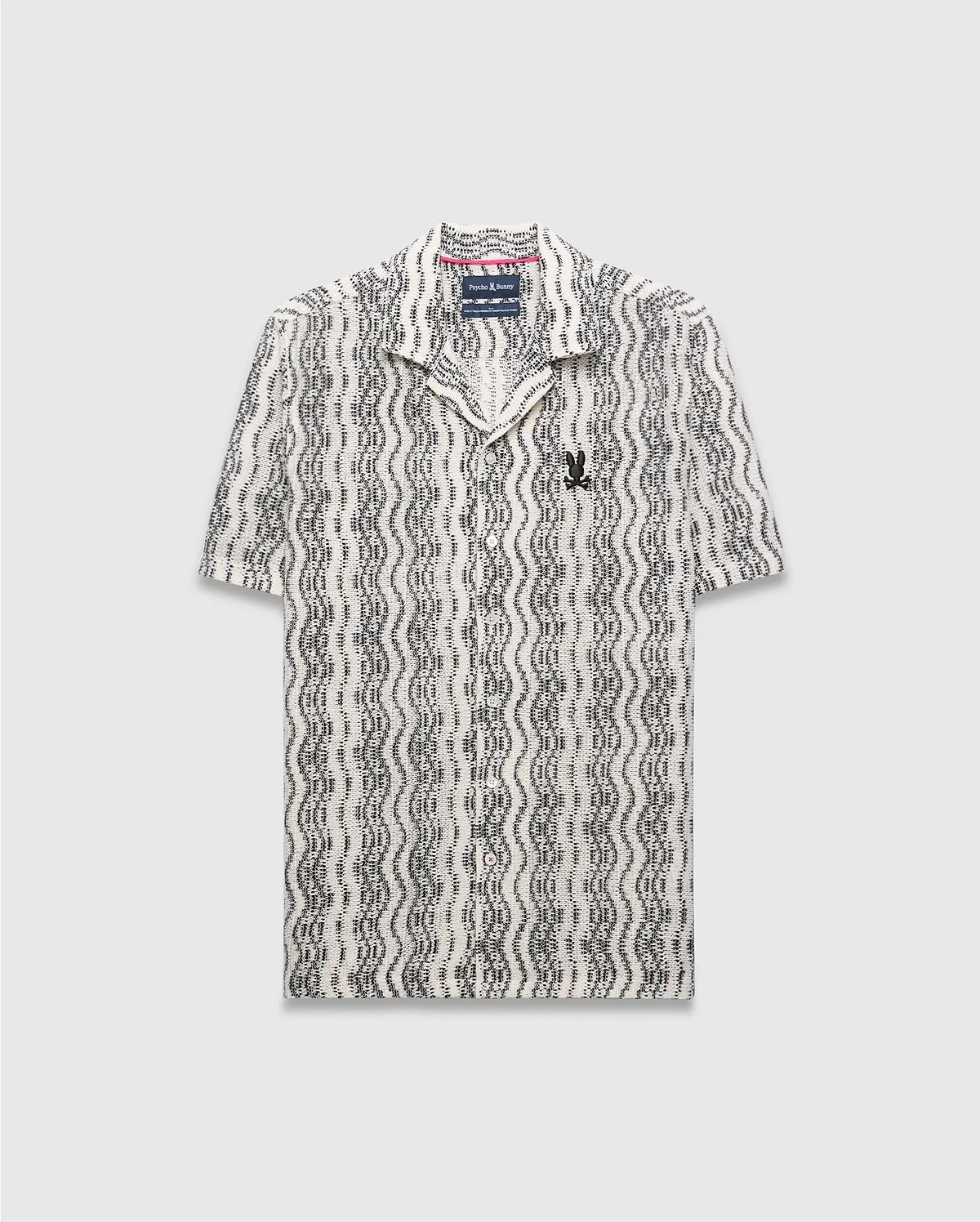 Mens Dave Crochet Shirt, a cream and black wavy patterned crochet knit short-sleeve button-up with an open collar and a small embroidered black Psycho Bunny skull logo on the left chest. (6)