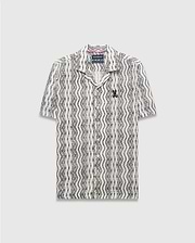 Mens Dave Crochet Shirt, a cream and black wavy patterned crochet knit short-sleeve button-up with an open collar and a small embroidered black Psycho Bunny skull logo on the left chest. (6)