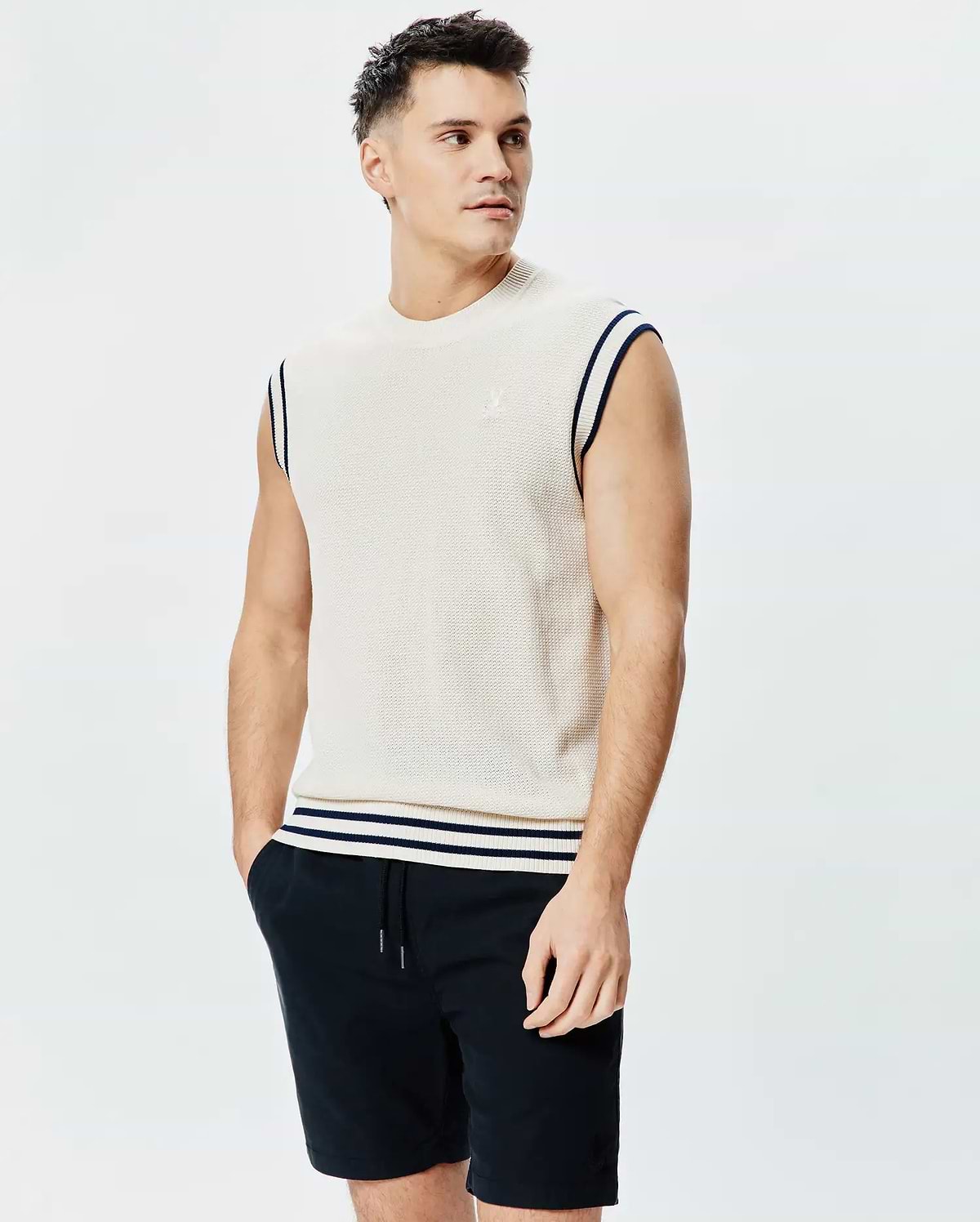 Mens Peter Knit Vest, cream textured knit with navy striped armholes and hem, featuring a small embroidered Psycho Bunny skull logo on the left chest.