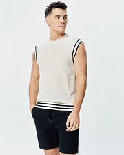 Mens Peter Knit Vest, cream textured knit with navy striped armholes and hem, featuring a small embroidered Psycho Bunny skull logo on the left chest.