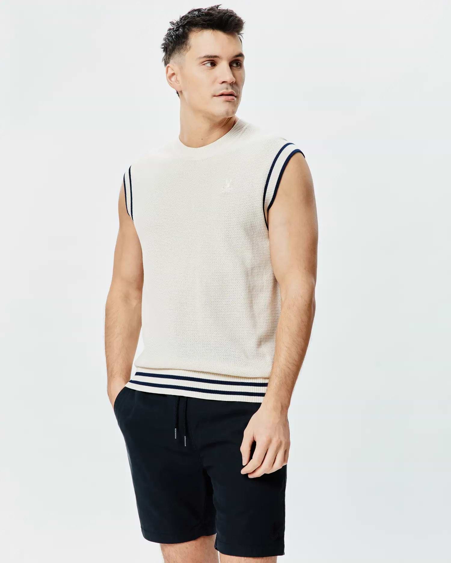 Mens Peter Knit Vest, cream textured knit with navy striped armholes and hem, featuring a small embroidered Psycho Bunny skull logo on the left chest.