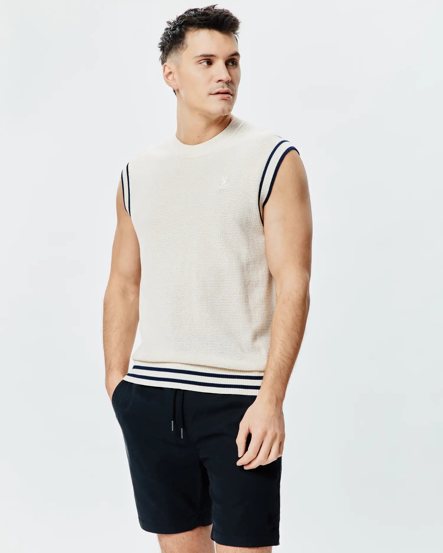 Mens Peter Knit Vest, cream textured knit with navy striped armholes and hem, featuring a small embroidered Psycho Bunny skull logo on the left chest.
