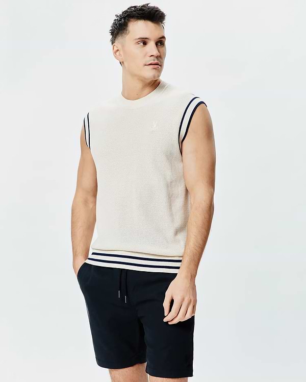 Mens Peter Knit Vest, cream textured knit with navy striped armholes and hem, featuring a small embroidered Psycho Bunny skull logo on the left chest.