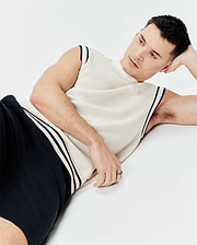 Cream Mens Peter Knit Vest with a relaxed fit, featuring a visible knit texture, navy blue striped trim on armholes and hem, and a small embroidered Psycho Bunny skull logo on the left chest.