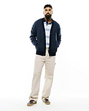 Mens Atkinson Cardigan, a navy blue relaxed fit waffle knit cardigan with a button-front, ribbed trim, two front pockets, and a small embroidered Psycho Bunny skull logo on the left chest.