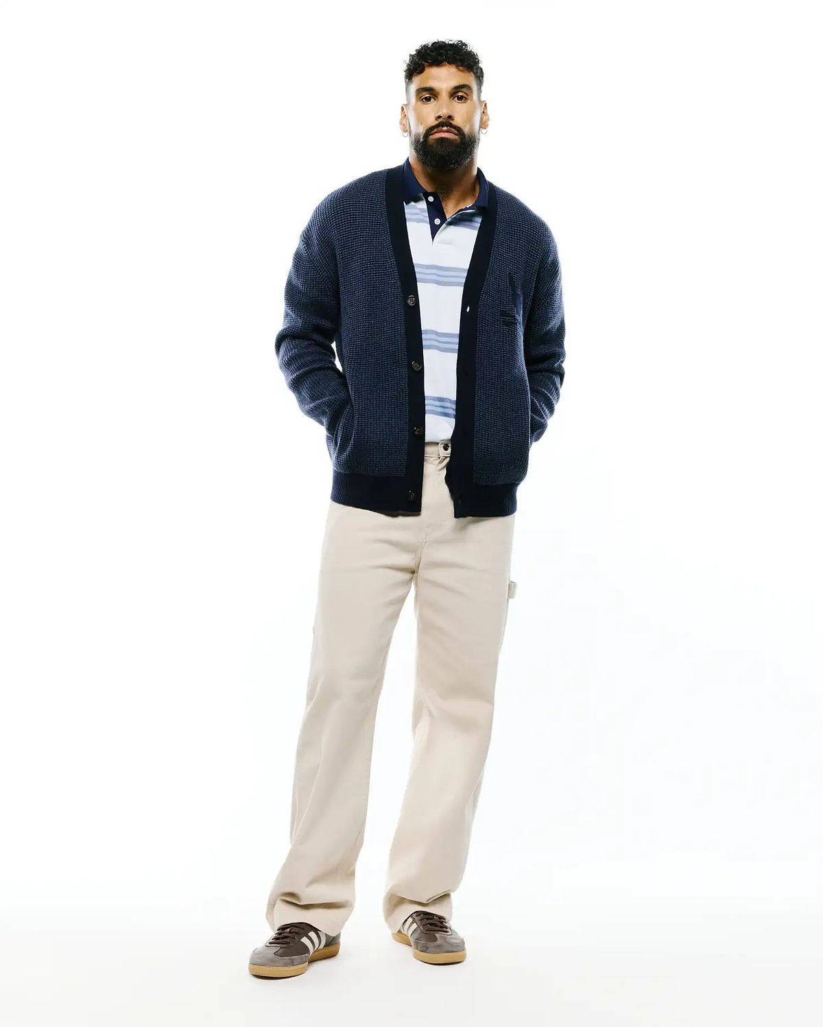 Mens Atkinson Cardigan, a navy blue relaxed fit waffle knit cardigan with a button-front, ribbed trim, two front pockets, and a small embroidered Psycho Bunny skull logo on the left chest.