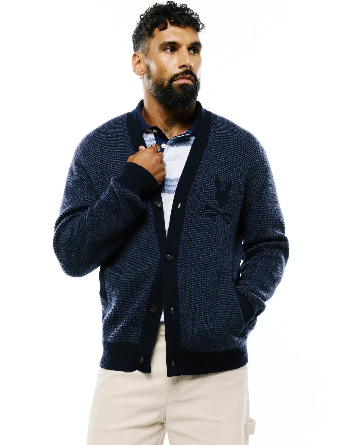 Mens Atkinson Cardigan, a navy blue waffle knit cardigan with a classic fit, featuring a darker navy trim, brown buttons, and an embroidered Psycho Bunny skull logo on the left chest.