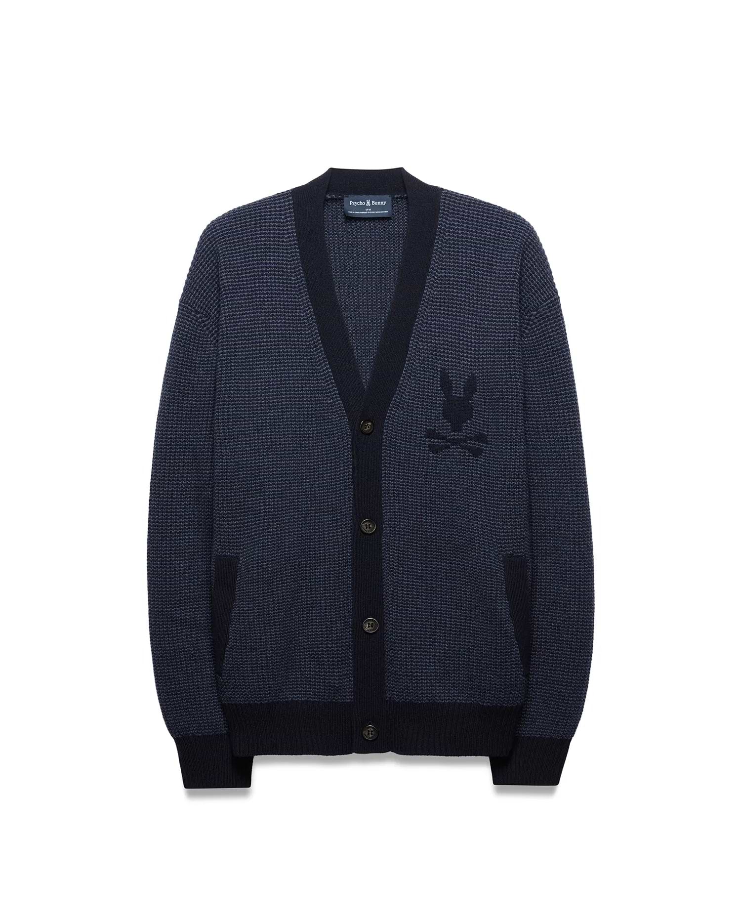 Mens Atkinson Cardigan, a navy blue waffle knit with dark navy ribbed V-neck, cuffs, and hem. Features a button-front, two patch pockets, and a prominent embroidered Psycho Bunny skull logo on the left chest.