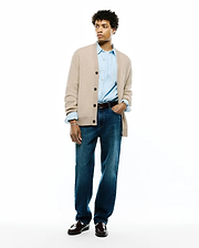 Mens Atkinson Cardigan in beige waffle knit, featuring dark brown buttons and a relaxed fit. Paired with a light blue shirt with a small embroidered Psycho Bunny skull logo.