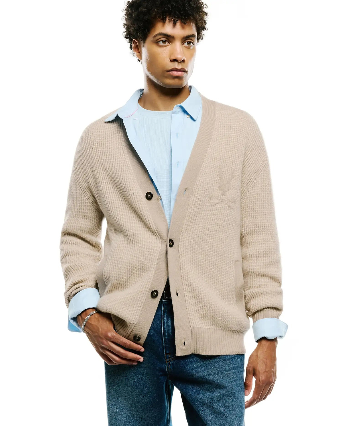 Mens Atkinson Cardigan: Classic fit beige waffle knit cardigan with dark brown buttons and a subtle tonal Psycho Bunny skull logo embroidered on the left chest.