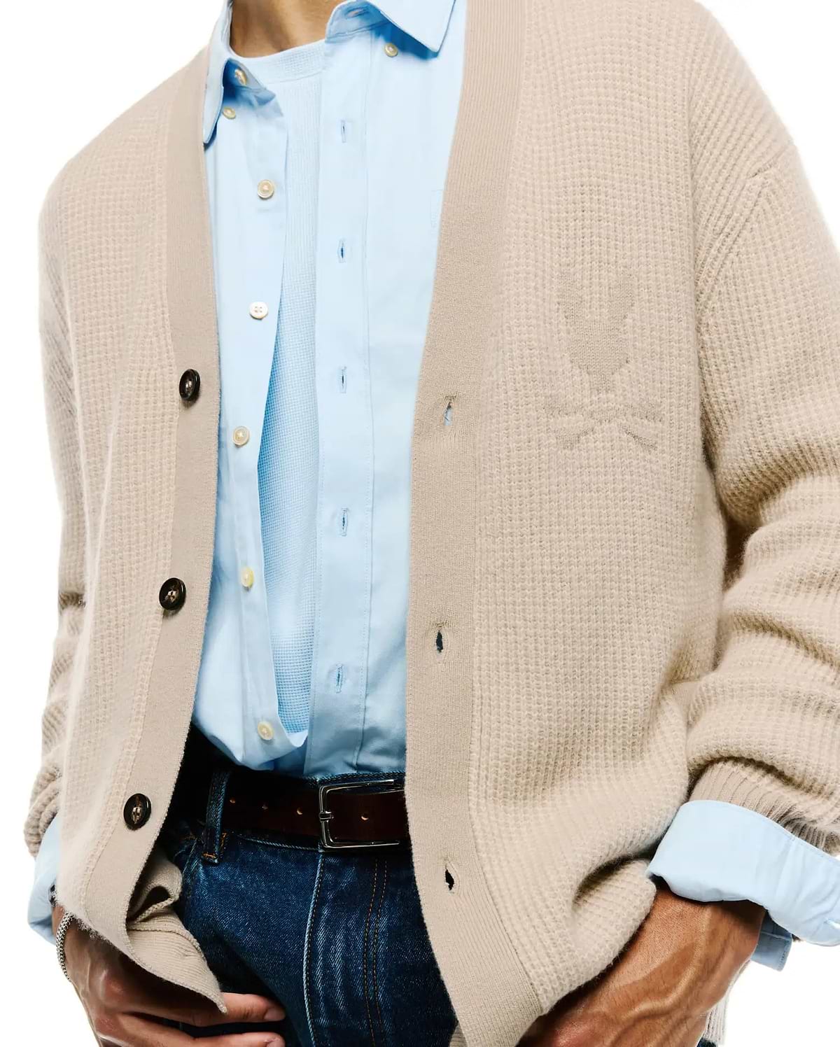 Mens Atkinson Cardigan in a relaxed fit, featuring a light beige waffle knit texture, dark brown buttons, and a subtle, tone-on-tone embroidered Psycho Bunny skull logo on the left chest.