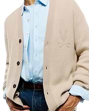 Mens Atkinson Cardigan in a relaxed fit, featuring a light beige waffle knit texture, dark brown buttons, and a subtle, tone-on-tone embroidered Psycho Bunny skull logo on the left chest.