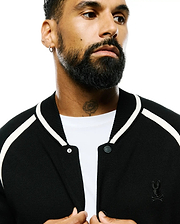 Black Mens Rafferty Cardigan, a classic fit fine knit with white varsity stripes, branded snap buttons, and a small embroidered black Psycho Bunny skull logo on the left chest.