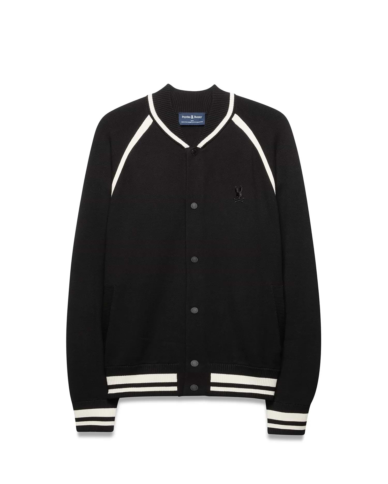 Mens Rafferty Cardigan: Black knit varsity cardigan with white stripe accents on ribbed collar, raglan sleeves, cuffs, and hem, featuring snap buttons and a small embroidered Psycho Bunny skull logo on the left chest.